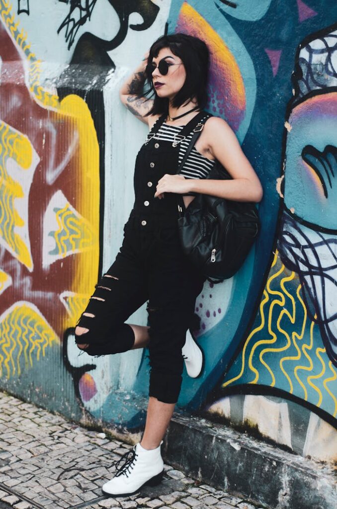 Woman Leaning on Wall With Mural